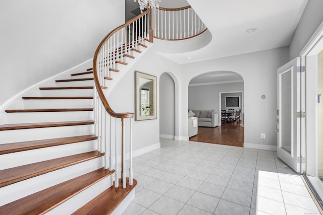 21 Centennial Dr, Danbury, CT 06811 - foyer featuring tile patterned flooring, arched walkways, baseboards, and stairway
