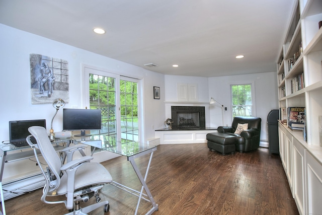 home office featuring a baseboard radiator, dark wood-type flooring, visible vents, and recessed lighting