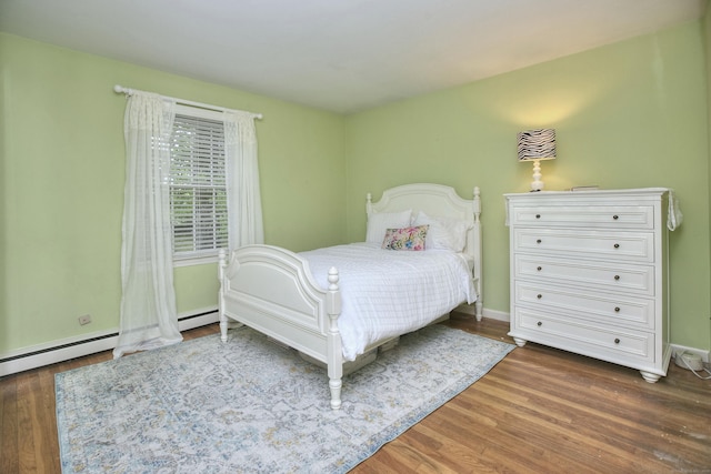 bedroom with baseboards and wood finished floors