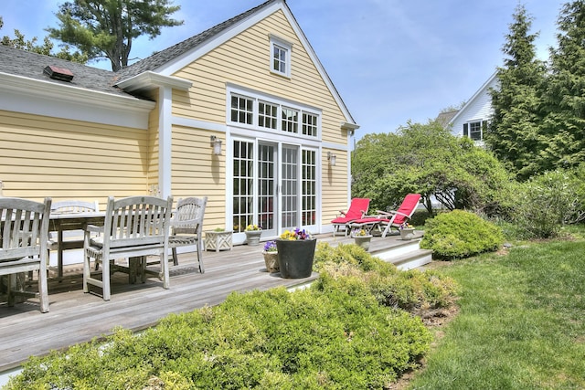 rear view of property featuring a deck