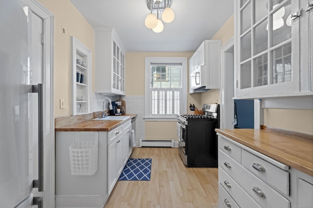 498 Whitney Ave Unit 1D, New Haven, CT 06511 - kitchen featuring stainless steel appliances, wood counters, a sink, light wood finished floors, and white cabinetry