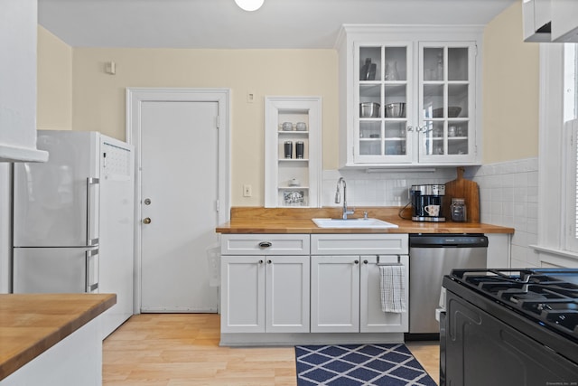 498 Whitney Ave Unit 1D, New Haven, CT 06511 - kitchen with wooden counters, black range with gas cooktop, a sink, light wood finished floors, and freestanding refrigerator
