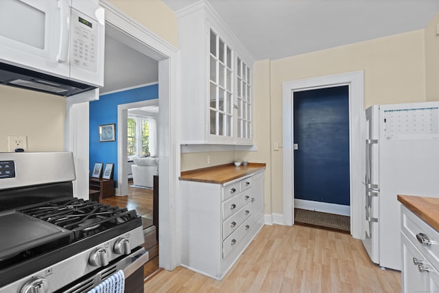 498 Whitney Ave Unit 1D, New Haven, CT 06511 - kitchen with butcher block counters, white appliances, light wood-type flooring, and white cabinets