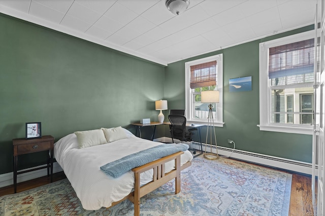 498 Whitney Ave Unit 1D, New Haven, CT 06511 - bedroom featuring wood finished floors, baseboards, a baseboard radiator, and ornamental molding