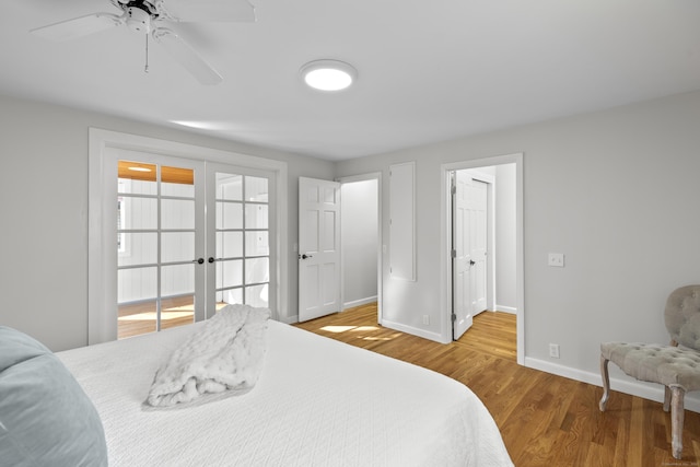 bedroom featuring french doors, baseboards, and wood finished floors