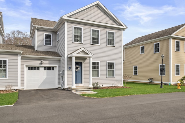 view of front of property featuring an attached garage, roof with shingles, and driveway