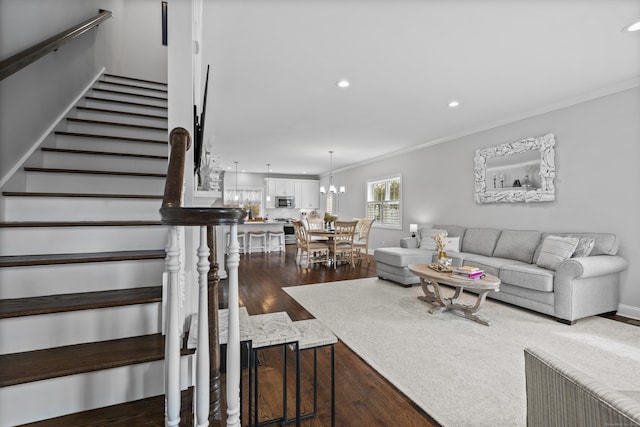 living area featuring crown molding, recessed lighting, wood finished floors, and stairway