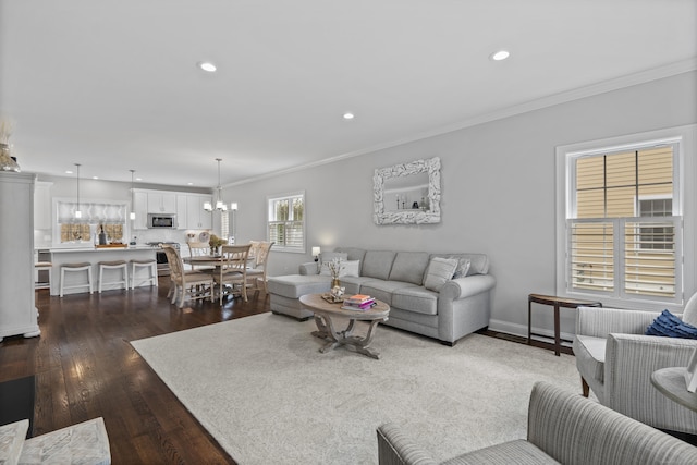 living area with crown molding, baseboards, dark wood-style floors, recessed lighting, and a chandelier