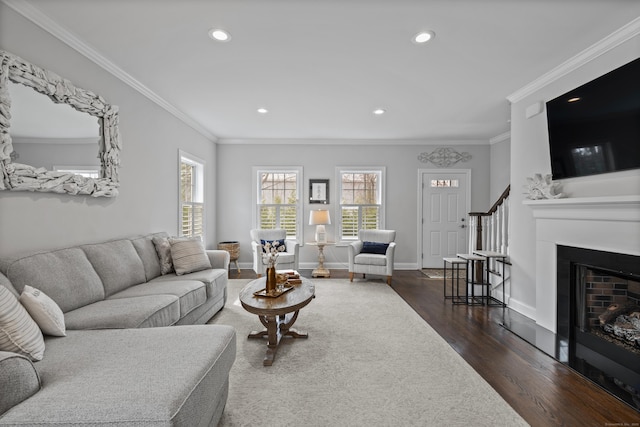 living room with crown molding, dark wood-style flooring, a fireplace, baseboards, and recessed lighting