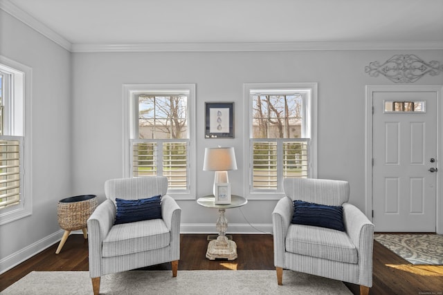 sitting room featuring crown molding, baseboards, wood finished floors, and a wealth of natural light