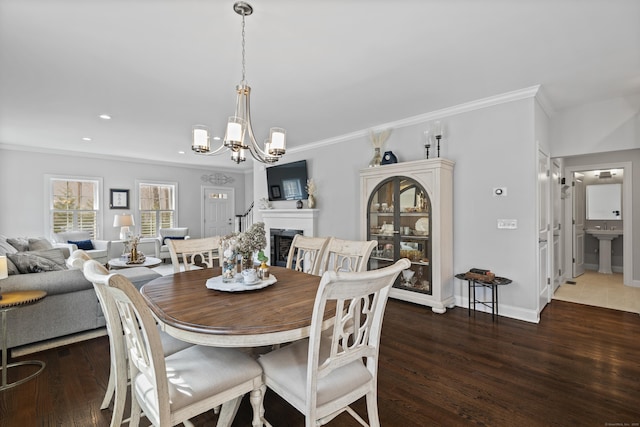 dining space with crown molding, baseboards, an inviting chandelier, and dark wood-type flooring