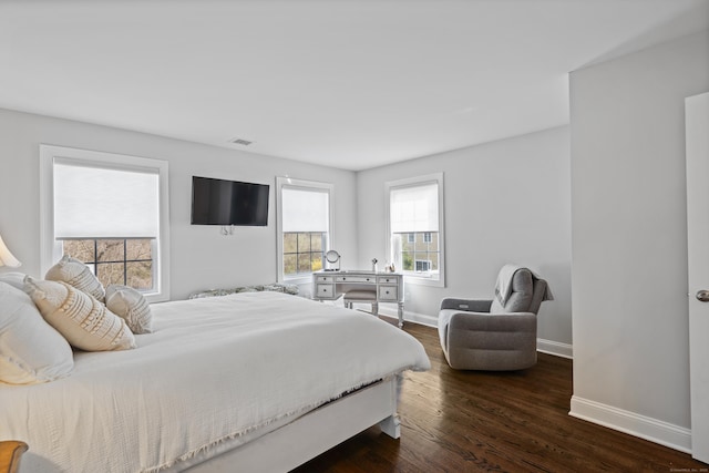 bedroom featuring baseboards, visible vents, and dark wood-style floors