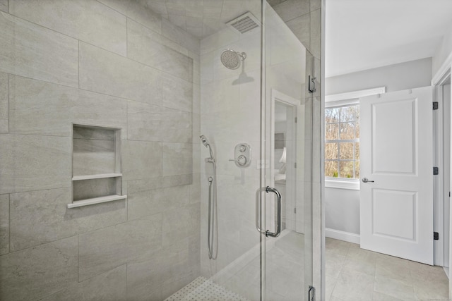 bathroom featuring baseboards, visible vents, and a stall shower