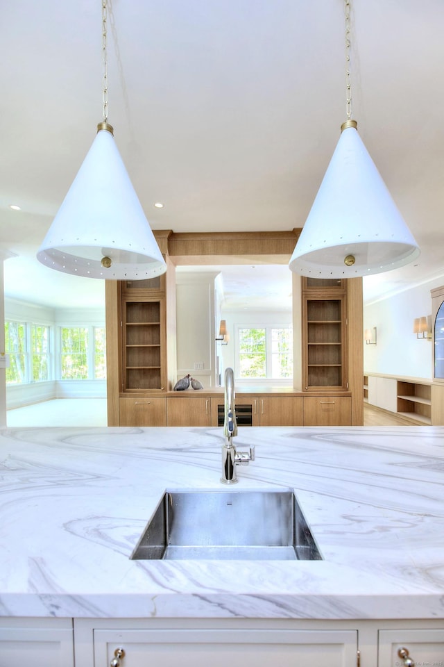 7 Brookside Dr, Westport, CT 06880 - kitchen with a sink, open shelves, pendant lighting, and light stone countertops