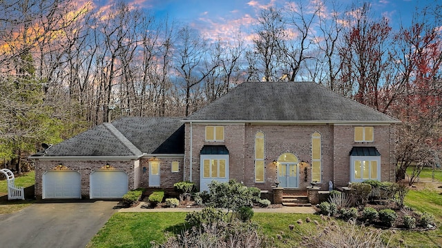 17 Hidden Oak Dr, Farmington, CT 06032 - colonial home featuring a garage, driveway, brick siding, roof with shingles, and a front lawn