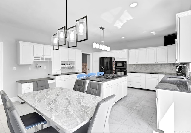 17 Hidden Oak Dr, Farmington, CT 06032 - kitchen with black appliances, a center island, dark stone counters, decorative backsplash, and white cabinets