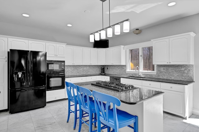 17 Hidden Oak Dr, Farmington, CT 06032 - kitchen featuring black appliances, light marble finish floors, tasteful backsplash, a center island, and recessed lighting