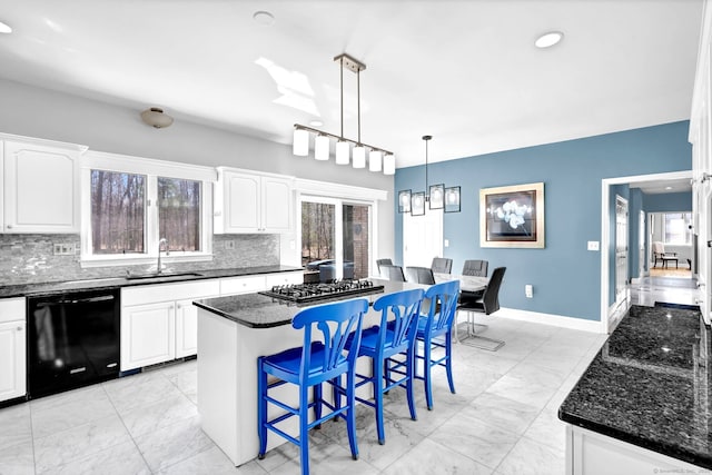 17 Hidden Oak Dr, Farmington, CT 06032 - kitchen featuring black dishwasher, stainless steel gas cooktop, tasteful backsplash, a breakfast bar, and white cabinets