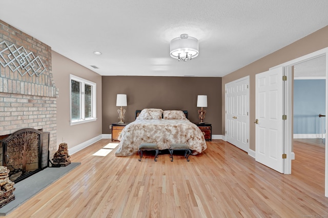 17 Hidden Oak Dr, Farmington, CT 06032 - bedroom with wood finished floors and a brick fireplace