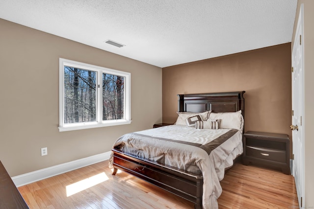 17 Hidden Oak Dr, Farmington, CT 06032 - bedroom featuring wood finished floors and a textured ceiling