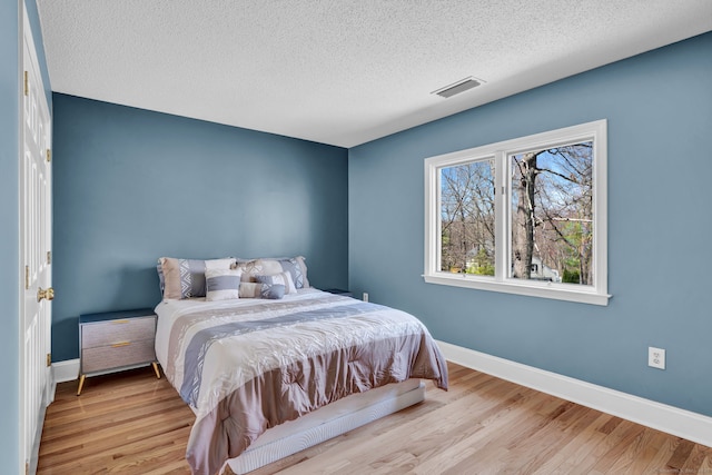 17 Hidden Oak Dr, Farmington, CT 06032 - bedroom featuring a textured ceiling and wood finished floors