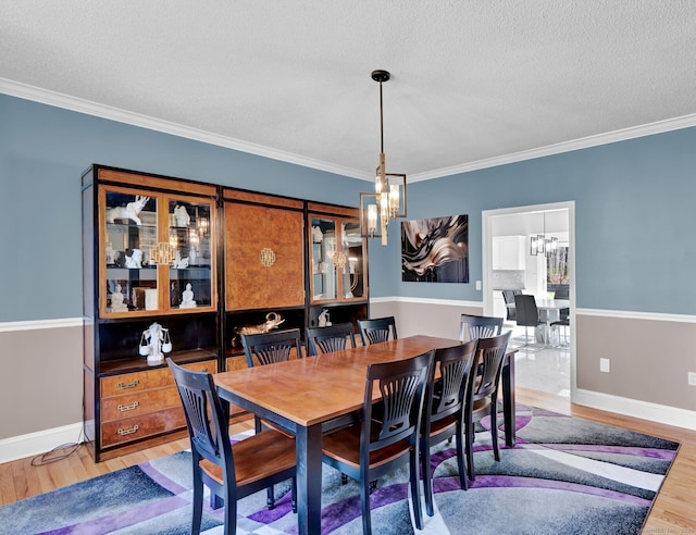 17 Hidden Oak Dr, Farmington, CT 06032 - dining room with a chandelier, light wood-type flooring, crown molding, and a textured ceiling