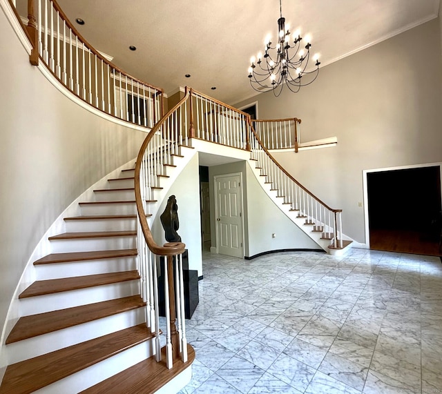 17 Hidden Oak Dr, Farmington, CT 06032 - staircase with marble look tiles, a towering ceiling, a chandelier, and crown molding