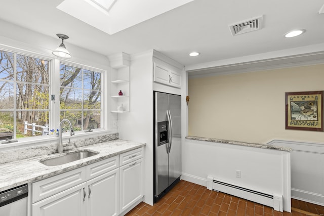 kitchen with dishwasher, visible vents, a sink, a baseboard heating unit, and stainless steel fridge