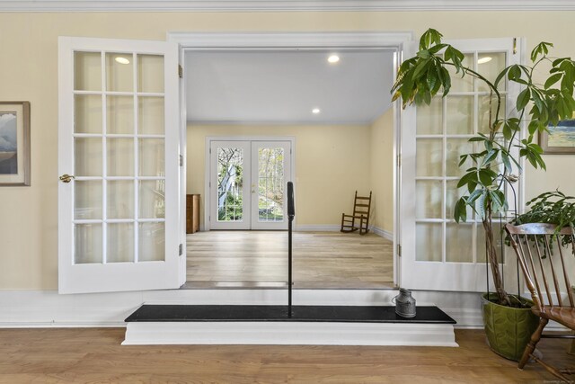 doorway to outside with recessed lighting, wood finished floors, and french doors