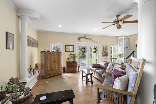 living room featuring ceiling fan, ornamental molding, wood finished floors, and ornate columns