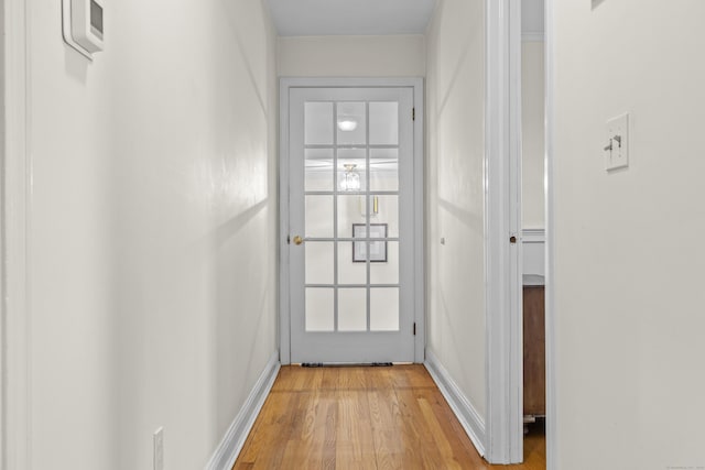 entryway with light wood finished floors and baseboards