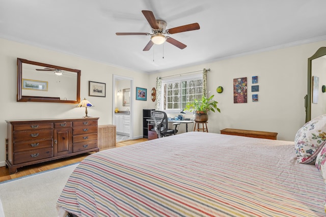 bedroom with light wood-style floors, crown molding, a ceiling fan, and connected bathroom