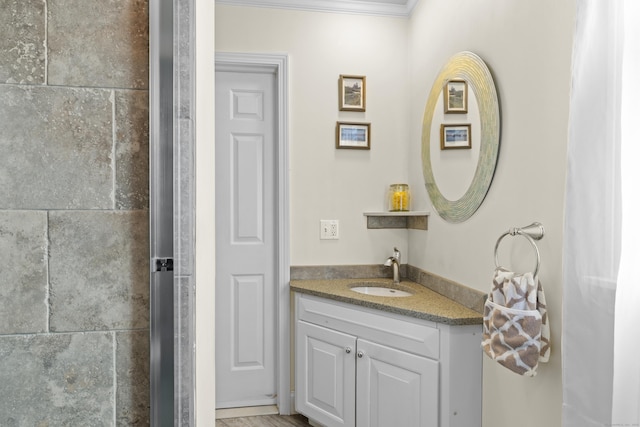 bathroom with ornamental molding and vanity