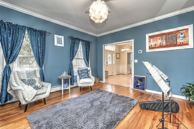 340 Webb Cir, Monroe, CT 06468 - living area featuring ornamental molding, a notable chandelier, wood finished floors, and plenty of natural light