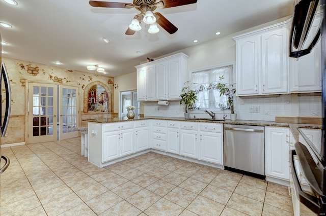 340 Webb Cir, Monroe, CT 06468 - kitchen with a peninsula, dishwasher, white cabinetry, and ceiling fan