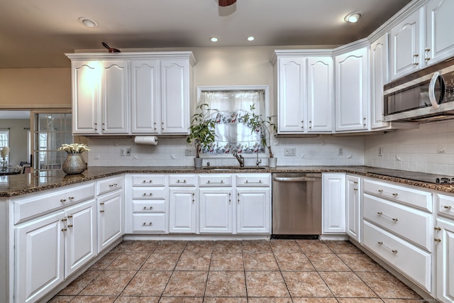 340 Webb Cir, Monroe, CT 06468 - kitchen with decorative backsplash, white cabinetry, stainless steel appliances, and a sink