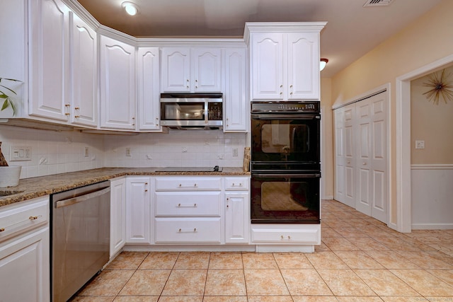 340 Webb Cir, Monroe, CT 06468 - kitchen featuring white cabinets, light tile patterned flooring, decorative backsplash, and black appliances