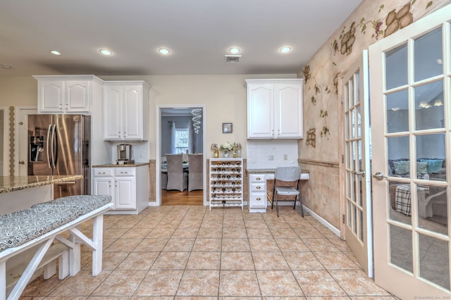340 Webb Cir, Monroe, CT 06468 - kitchen with white cabinets, stainless steel fridge with ice dispenser, visible vents, french doors, and light stone countertops
