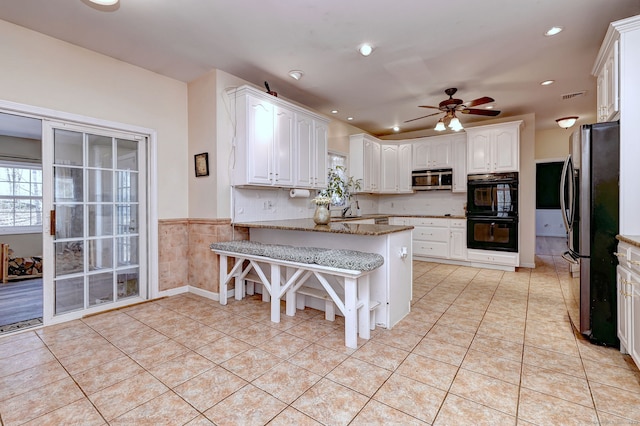 340 Webb Cir, Monroe, CT 06468 - kitchen with a ceiling fan, stainless steel appliances, white cabinets, a peninsula, and light stone countertops