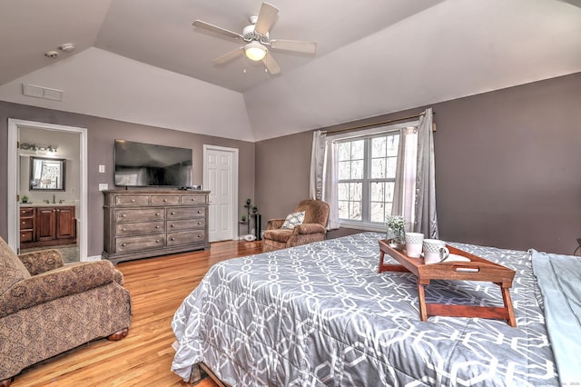 340 Webb Cir, Monroe, CT 06468 - bedroom featuring ensuite bath, light wood-style floors, vaulted ceiling, a sink, and visible vents