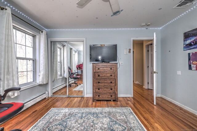 340 Webb Cir, Monroe, CT 06468 - bedroom with a baseboard heating unit, baseboards, wood finished floors, and visible vents