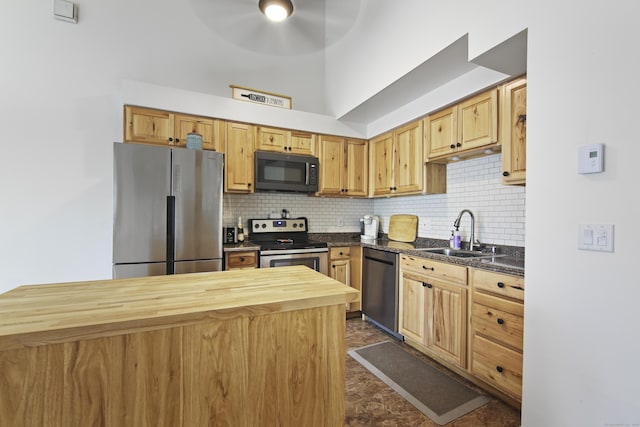 kitchen featuring tasteful backsplash, a sink, ceiling fan, stainless steel appliances, and butcher block counters