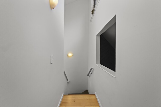 staircase with wood finished floors