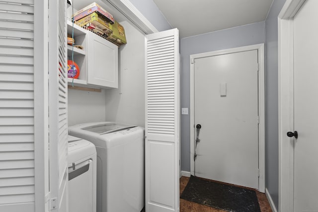 washroom with washing machine and clothes dryer and cabinet space