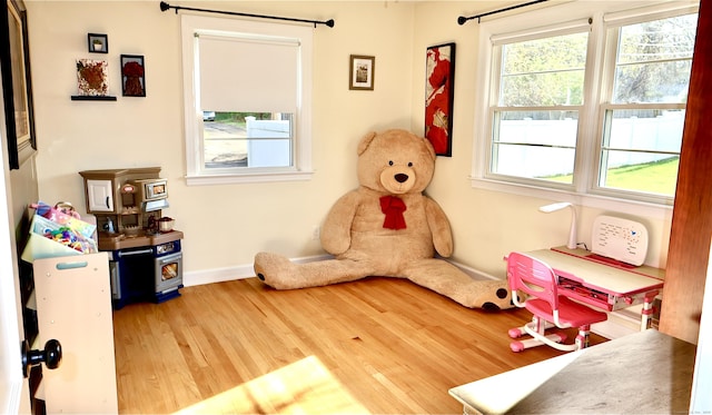 rec room with wood finished floors and baseboards
