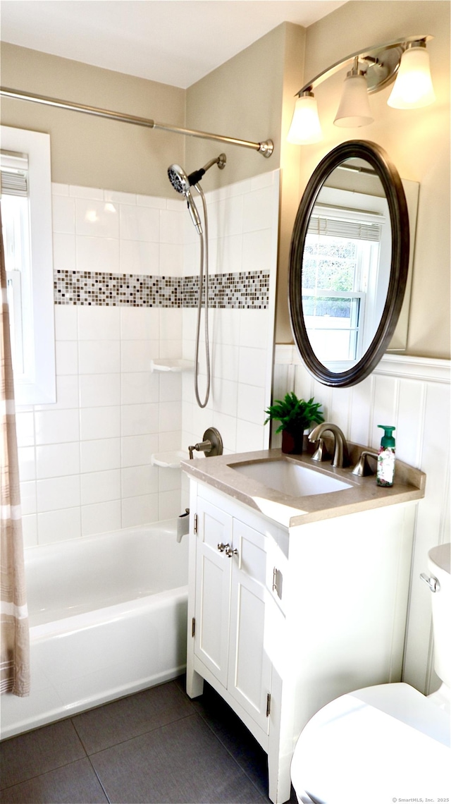 bathroom with tile patterned floors, vanity, toilet, and shower / tub combo with curtain