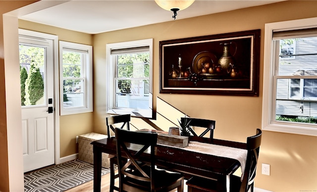 dining space with wood finished floors and baseboards