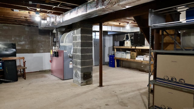 unfinished below grade area featuring heating unit