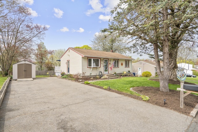 98 Cynthia Dr, West Haven, CT 06516 - view of front of home with a chimney, fence, an outbuilding, a storage shed, and a front yard