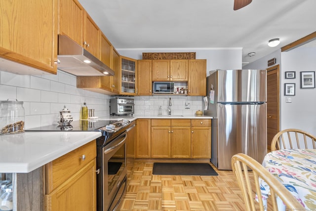 98 Cynthia Dr, West Haven, CT 06516 - kitchen with a sink, appliances with stainless steel finishes, light countertops, under cabinet range hood, and backsplash